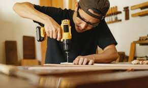 Handyman using a power drill on a wood installation project
