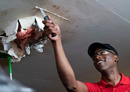Handyman repairing a drywall ceiling