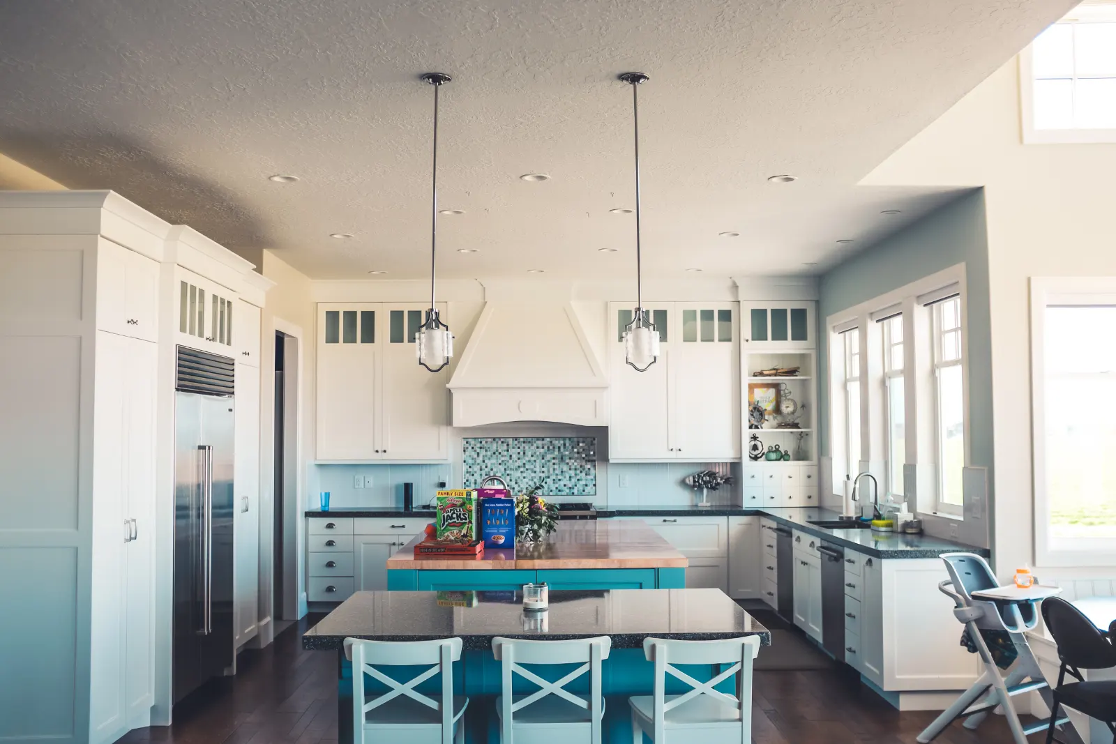 Bright open kitchen with a blue island and white cabinets