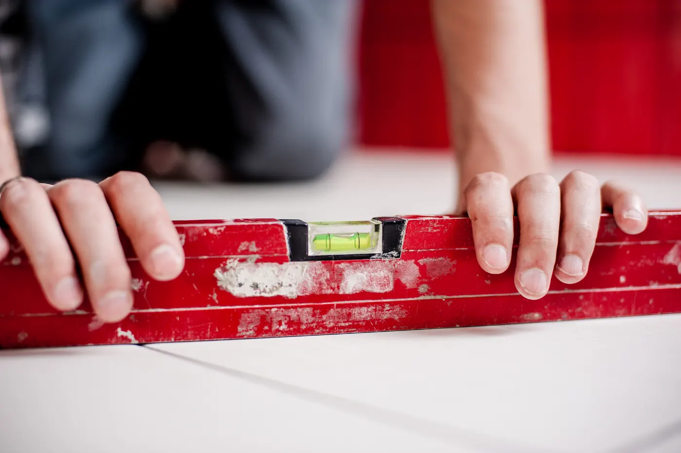 Handyman checking a surface with a red spirit level